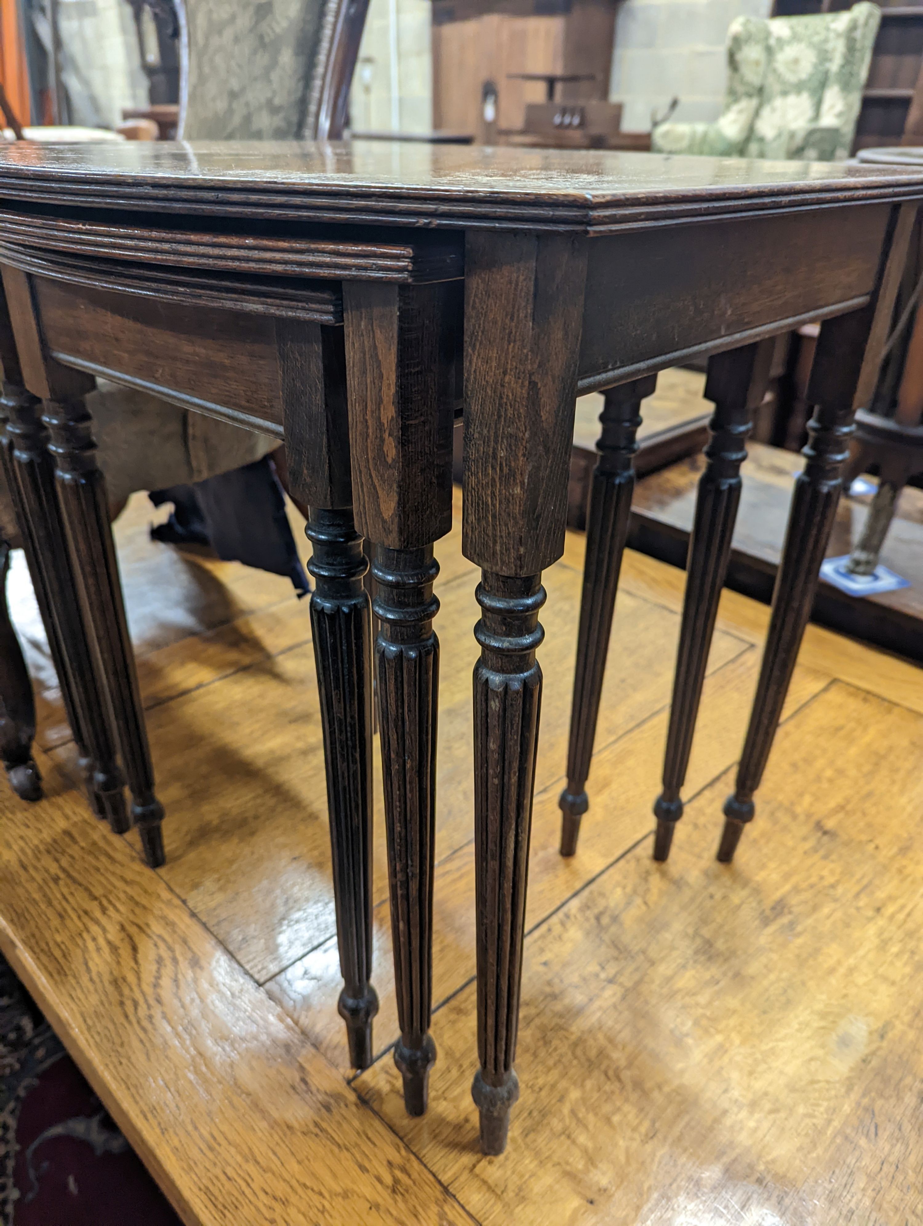 A Victorian walnut nursing chair together with a reproduction nest of tea tables